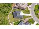 Aerial view shows the home's dark roof, the long driveway, the manicured lawn, and a brick perimeter wall at 205 Waterfall Circle, Little River, SC 29566
