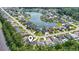 An aerial view highlights homes in a scenic neighborhood with a large lake, offering a picturesque and desirable location at 205 Waterfall Circle, Little River, SC 29566