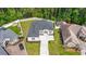 Aerial view of home with a dark roof, a long driveway, and a yard enclosed by a brick perimeter wall at 205 Waterfall Circle, Little River, SC 29566