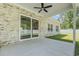 Covered brick patio with fan overlooks the backyard, accessible through sliding glass doors for seamless indoor/outdoor living at 205 Waterfall Circle, Little River, SC 29566