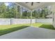 Covered patio overlooks a flat, grassy backyard with a concrete perimeter wall, offering privacy and outdoor space at 205 Waterfall Circle, Little River, SC 29566