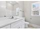 Bright bathroom featuring a white vanity, mirror, window, and shower/tub combo at 205 Waterfall Circle, Little River, SC 29566