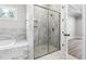 Bathroom with marble tile throughout, glass enclosed shower and soaking tub at 205 Waterfall Circle, Little River, SC 29566