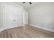 Bedroom features large closet doors, light wood floors, and a ceiling fan at 205 Waterfall Circle, Little River, SC 29566