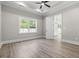 Bright bedroom with hardwood floors, tray ceiling and a large window with backyard view at 205 Waterfall Circle, Little River, SC 29566