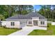 Charming brick home featuring a well-manicured lawn and attached two-car garage at 205 Waterfall Circle, Little River, SC 29566