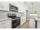Kitchen features stainless steel appliances, white cabinets, and light countertops at 205 Waterfall Circle, Little River, SC 29566