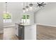 Spacious kitchen with an island, pendant lights, and stainless steel appliances at 205 Waterfall Circle, Little River, SC 29566