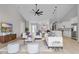 Stylish living room with vaulted ceiling, wood floor, ceiling fan, kitchen island, and white sofas at 205 Waterfall Circle, Little River, SC 29566