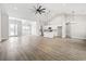 Open-concept living area with lots of light, wood floor, and views of the kitchen and dining room at 205 Waterfall Circle, Little River, SC 29566
