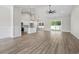 Open-concept living space featuring wood flooring, white cabinetry, and sliding doors to backyard at 205 Waterfall Circle, Little River, SC 29566