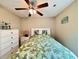 Bedroom with a ceiling fan, bed with palm-leaf comforter, dresser, and wall art at 209 Foxpath Loop, Myrtle Beach, SC 29588