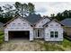 Home under construction, wrapped in protective sheathing, new front door and window at 269 Waterfall Circle, Little River, SC 29566