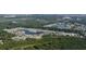 An aerial view of a community surrounded by lush green trees and winding lakes at 277 Waterfall Circle, Little River, SC 29566
