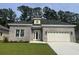 Charming single-story home featuring a brick facade, attached garage, and well-manicured lawn at 289 Waterfall Circle, Little River, SC 29566