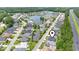 This aerial view showcases the neighborhood's location, featuring a community lake and manicured landscaping at 297 Waterfall Circle, Little River, SC 29566
