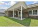This covered patio is perfect for outdoor entertaining, seamlessly blending indoor-outdoor living with ample space at 297 Waterfall Circle, Little River, SC 29566
