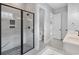 Modern bathroom showcasing a glass shower, black fixtures, and honeycomb flooring and a doorway to the water closet at 297 Waterfall Circle, Little River, SC 29566