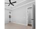 Spacious bedroom featuring tray ceilings, neutral walls, plush carpeting, and an open doorway for natural light at 297 Waterfall Circle, Little River, SC 29566