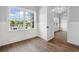 Bright dining area featuring hardwood floors, wainscoting, a large window with natural light, and neutral paint at 297 Waterfall Circle, Little River, SC 29566