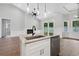Modern kitchen flows into living space, with a large island and stone countertops at 297 Waterfall Circle, Little River, SC 29566