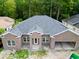 Aerial view of home with a large roof, and lush backyard at 309 Waterfall Circle, Little River, SC 29566