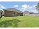 Brick home with expansive, well-maintained backyard lawn, bathed in sunlight at 309 Waterfall Circle, Little River, SC 29566