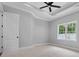 Bedroom with a large window and a ceiling fan, creating a cozy and well-lit space at 309 Waterfall Circle, Little River, SC 29566