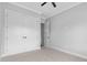 A large walk-in closet features double doors and neutral carpet and paint at 309 Waterfall Circle, Little River, SC 29566