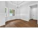 Dining room with wainscoting, tray ceiling and luxury wood-style flooring at 309 Waterfall Circle, Little River, SC 29566