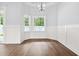 Bright dining room with wood floors and natural light from the windows at 309 Waterfall Circle, Little River, SC 29566