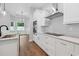 Bright kitchen with stainless steel appliances, white cabinets and marble countertops at 309 Waterfall Circle, Little River, SC 29566