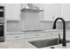 Close-up on kitchen appliances and stainless steel sink with marble countertop at 309 Waterfall Circle, Little River, SC 29566
