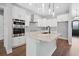 Kitchen island with marble countertop, stainless steel appliances, and double oven at 309 Waterfall Circle, Little River, SC 29566