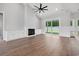 Bright living room featuring wood floors, a fireplace, built-in cabinets, and sliding glass doors at 309 Waterfall Circle, Little River, SC 29566