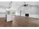 Open-concept living room features fireplace, ceiling fan, and luxury wood floors at 309 Waterfall Circle, Little River, SC 29566