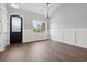 Bright, open room with wood floors, wainscoting, large window and decorative light fixture at 309 Waterfall Circle, Little River, SC 29566