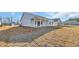 New construction home with covered patio and lawn at 329 Palmetto Sand Loop, Conway, SC 29527