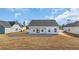 The back of this newly constructed home features a covered patio and expansive backyard at 329 Palmetto Sand Loop, Conway, SC 29527