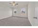 Bedroom with neutral carpet, ceiling fan, and natural light streaming through windows at 329 Palmetto Sand Loop, Conway, SC 29527
