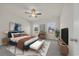 Furnished bedroom featuring modern décor, comfortable bed, and natural light from windows at 329 Palmetto Sand Loop, Conway, SC 29527