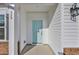 Close-up of a light blue front door with white trim and a modern lantern fixture at 329 Palmetto Sand Loop, Conway, SC 29527