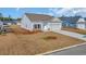 Charming single-story home with white siding, a two-car garage, and manicured front yard at 329 Palmetto Sand Loop, Conway, SC 29527