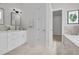 Well-lit bathroom featuring marble tile floors, a vanity with modern fixtures, and a door leading to the toilet room at 329 Waterfall Circle, Little River, SC 29566