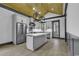 Modern kitchen with gray cabinets, an island, and a wood ceiling at 3880 Murrells Inlet Rd., Murrells Inlet, SC 29576