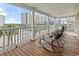 Spacious balcony with chairs offering a clear view of the city and palm trees at 5407 N Ocean Blvd., Myrtle Beach, SC 29577