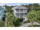 Two-story home featuring dual porches, with lush landscaping, and classic curb appeal at 5407 N Ocean Blvd., Myrtle Beach, SC 29577
