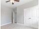 Spacious bedroom with neutral walls and carpet, featuring a ceiling fan and double doors at 650 Timber Creek Dr., Loris, SC 29569