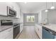 Bright kitchen featuring stainless steel appliances and open access to the dining area at 650 Timber Creek Dr., Loris, SC 29569