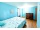 Bedroom with light blue walls, wood floors and a comfy bed at 704 9Th Ave. S, Myrtle Beach, SC 29577